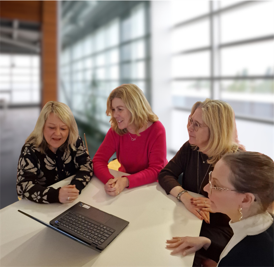 Kvinnor bakom runt ett bord som diskutera 360° Hälsoanalys för företag